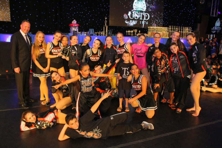 Group of young dancers posing with awards